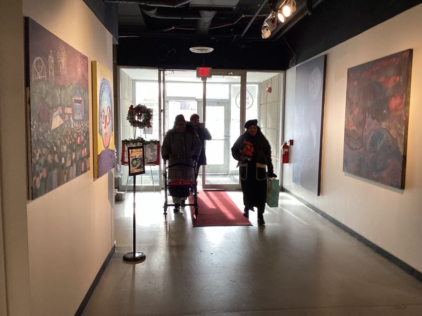 Wisdom people arriving safely at an indoor winter gathering, including a participant using a walker