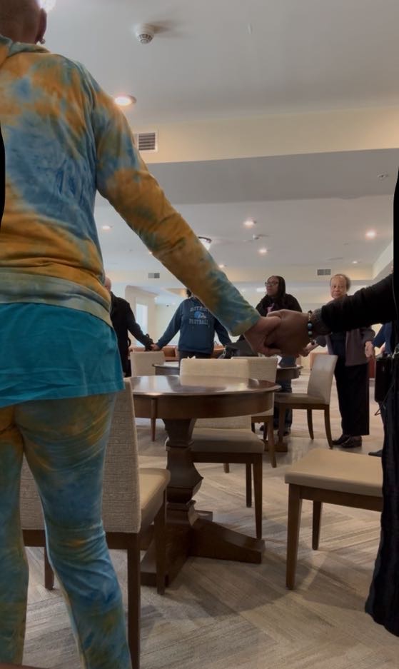 GOD’S Walking Club participants holding hands in a prayer circle