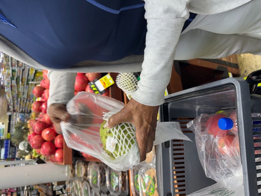 A wisdom person selecting fresh produce while shopping